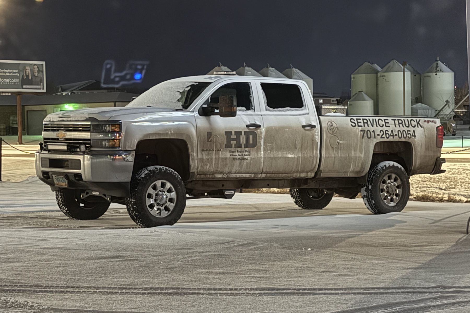 The HD Diesel service pickup, lettered SERVICE TRUCK with the shop phone number on the box, parked out on a yard